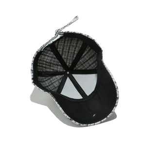 Detail of tweed baseball cap interior showing black lining and silver metal adjustment buckle