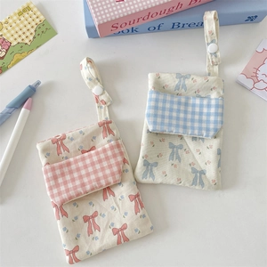 Detail of floral nurse pen pouch showing cotton fabric texture and snap button closure