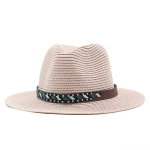 Close-up of bohemian beaded band and textured straw weave on a summer fedora