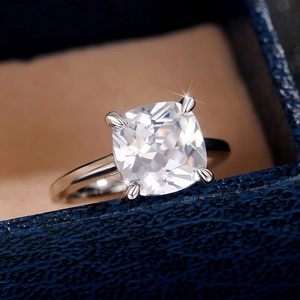 Macro shot of cushion-cut cubic zirconia in a classic four-prong silver setting