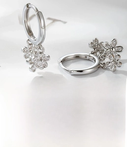 Detail macro view of silver flower earrings with zircon fringe and 10mm inner diameter