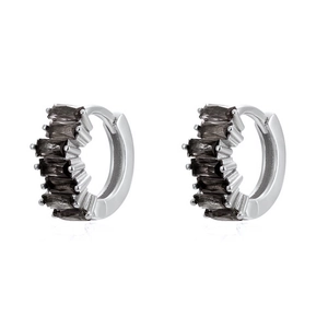 Detail of silver hoop earrings featuring baguette-cut black stones in a prong setting