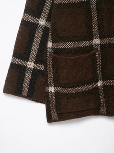 Close-up of brown checkered knitted cardigan showing fabric texture and pocket detail