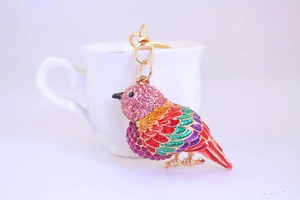 Macro shot of a colorful kingfisher keychain with vibrant rhinestones and gold plating