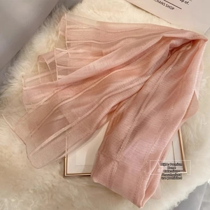 Close-up of pink silk wool striped scarf with delicate metallic gold line texture