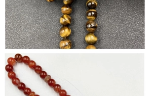 Detailed close-up showing golden tiger eye beads and translucent red agate prayer beads