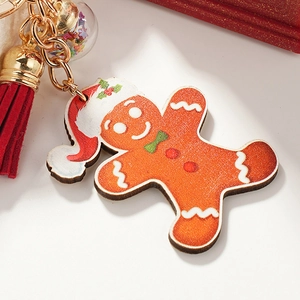 Porte-clés bonhomme de pain d'épices avec bonnet de Noël, pompon rouge et boule d'étoiles