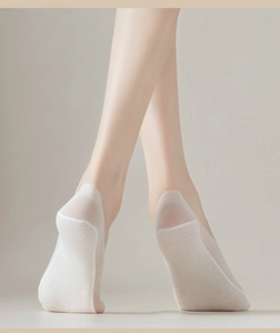 Close-up of white invisible boat socks for women with breathable cotton sole and thin mesh side