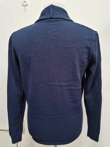 Detail view of dark blue men's knitted cardigan back texture on a white mannequin