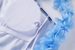 Detail of blue 3D floral applique on swimwear with breathable mesh lining and pad slot