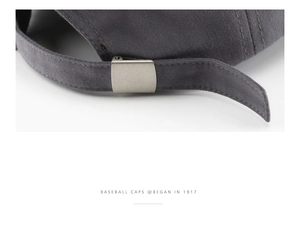 Detalle de hebilla metálica ajustable y correa de sarga en una gorra gris oscuro