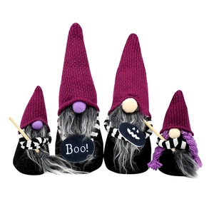 Set of four Halloween gnomes with purple hats and black bodies on white background