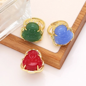 Detailed view of three colorful Buddha rings with gold bands and zircon accents