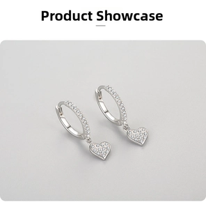 Macro shot of S925 silver heart drop earrings with pave cubic zirconia crystals