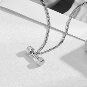 Detailed macro shot of silver dumbbell pendant with Phil 4:13 engraving on a chain