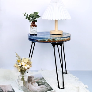 Detailed shot of an ocean-themed resin side table featuring seashell beach wave design