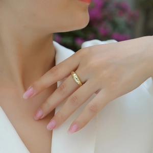 Close-up of elegant gold S925 silver ring featuring star setting stones on a female model
