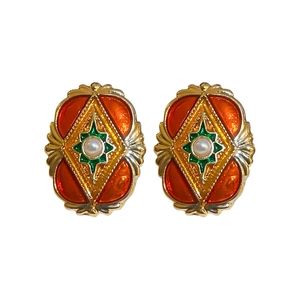 Vintage gold earrings with orange green enamel and center pearl in a court style design