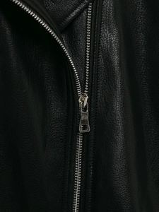 Close-up of high-quality black faux leather texture with silver metal zipper detail