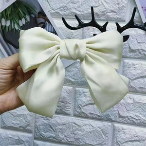 Large cream beige satin bow hair clip with glossy silk texture for elegant hairstyles