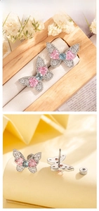 Detail of butterfly stud earring with pink and blue heart-shaped cubic zirconia stones