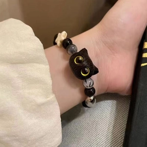 Cute black cat beaded bracelet with star accents and ink texture beads on wrist
