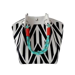 Elegant knit tote bag with black and white geometric stripes and colorful rope handle