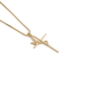 Detailed view of a gold cross pendant featuring colorful cubic zirconia on a box chain