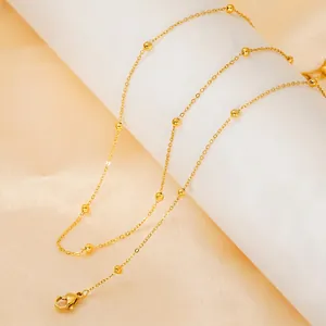 Elegant gold station bead necklace with polished stainless steel chain and lobster clasp