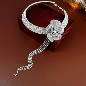 Exquisite silver flower necklace with tassels and rhinestones on a red jewelry box