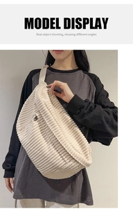 Detailed model shot of cream corduroy crossbody bag with adjustable strap and zip closure