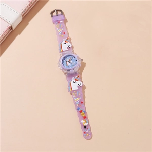 Detail of unicorn pattern silicone strap and purple LED watch for kids on a desk