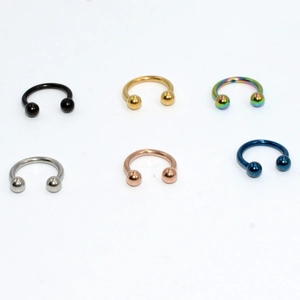 Detailed set of horseshoe-style body jewelry in black gold rainbow and silver finishes