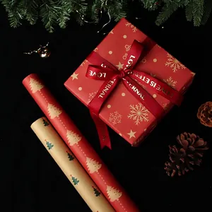 Christmas kraft wrapping paper rolls with snowflake patterns and gift box with silk ribbon