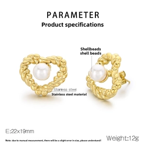 Detailed macro view of woven heart-shaped stainless steel earrings with white shell beads