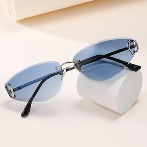 Detalle de gafas de sol de ojo de gato con lentes azules y puente metálico plateado