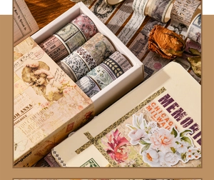 Detail shot of vintage washi tape rolls and notebook set with floral motifs and patterns