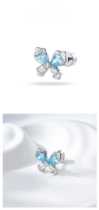 Detail of light blue zircon butterfly cartilage stud earring with flat screw back design