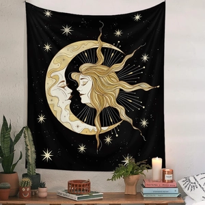 Detail of bohemian black wall tapestry with golden sun and moon in a cozy home setting