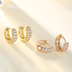 Elegant gold and rose gold huggie earrings with sparkling pavé zircons and heart details