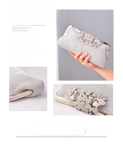 Detailed view of silver rhinestone evening clutch bag with ornate crystal floral clasp