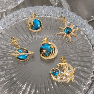 Detailed view of five gold-plated starry universe pendants with blue zircon accents