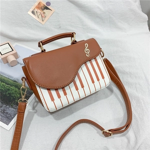 Chic piano key pattern crossbody bag in brown and white with musical note embroidery
