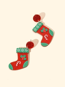 Detailed close-up of festive red Christmas stocking earrings with snowflake patterns