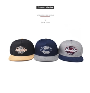 Detailed embroidery of Barber Brooklyn Shop logo on twill and suede baseball caps