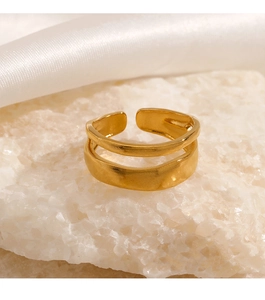 Detailed close-up of a double-layered gold open ring featuring a brushed matte metal finish