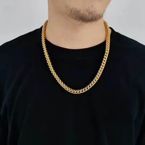 Detail of 6mm gold stainless steel Franco chain necklace worn by a male model