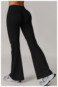 Macro view of high-waist yoga pants featuring ruched butt-lifting detail and flared leg