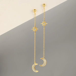 Detail of gold S925 sterling silver tassel earrings with star and crescent moon pendants