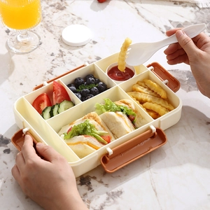 Portable beige bento box with divided compartments for salad and sandwiches on marble table